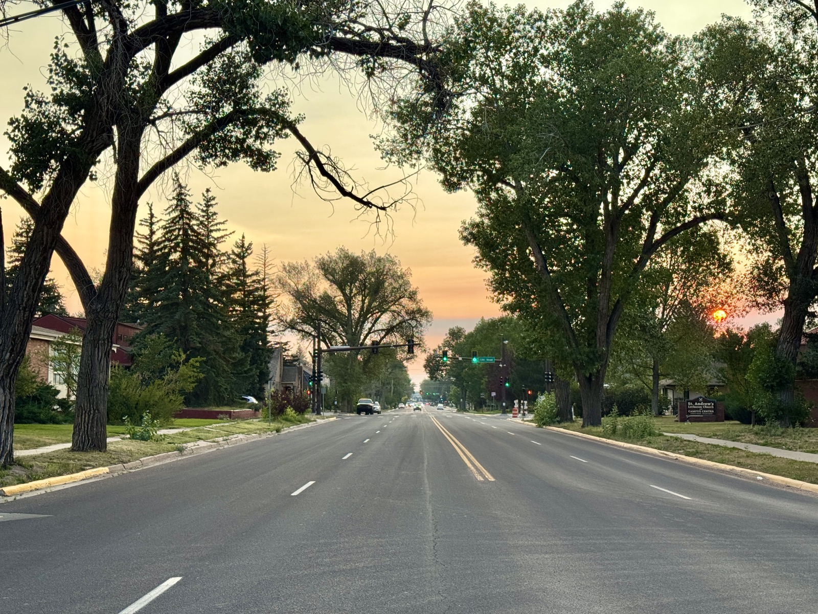 A tree-lined street in Laramie, Wyoming at sunset